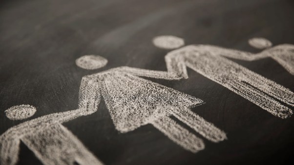 A chalk drawing of a family all holding hands