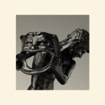 A statue of a man holding a mask