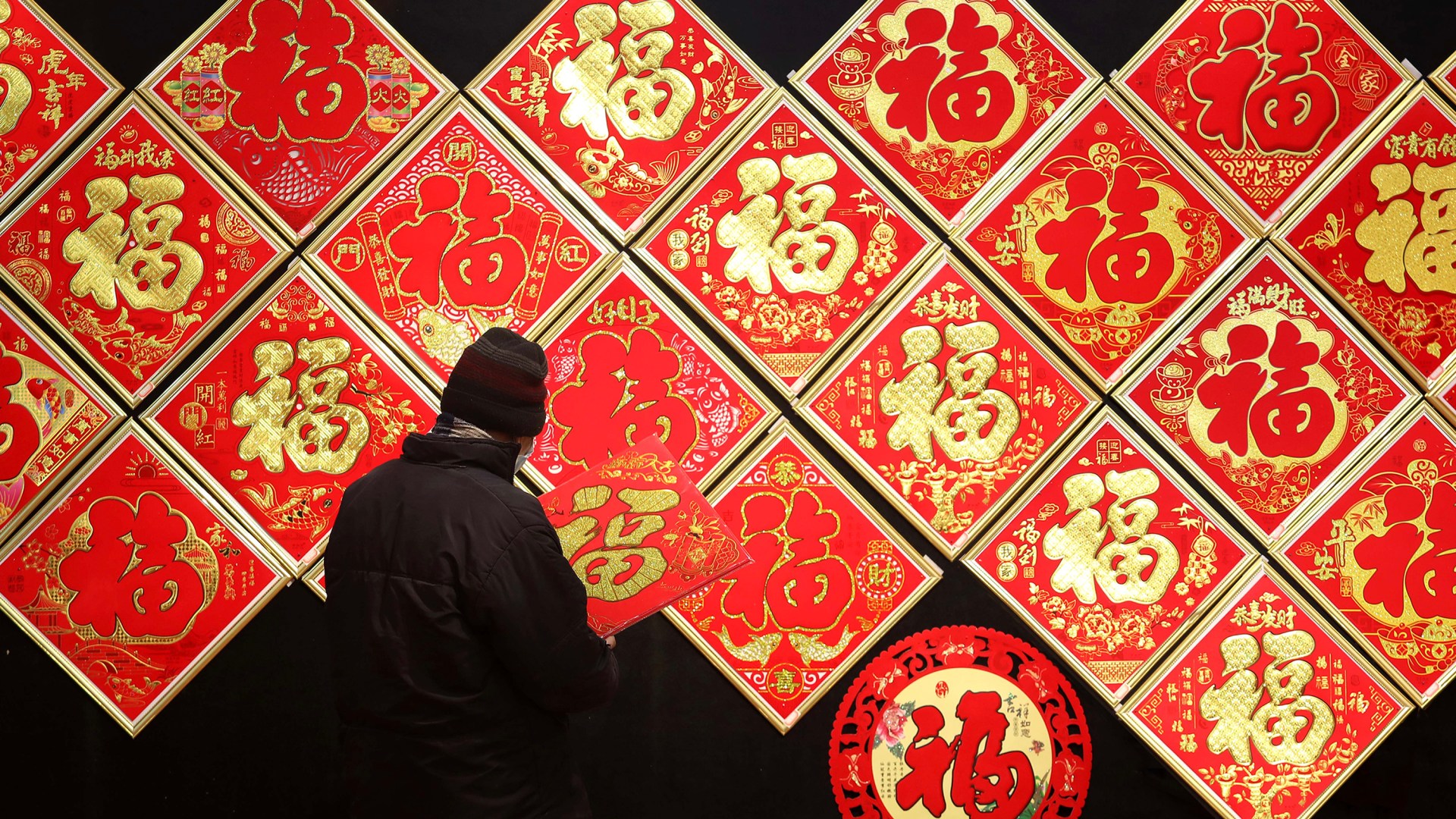 People purchase Fu character ornaments, which is the Mandarin character for "prosperity", for the upcoming Chinese New Year at a wholesale market.