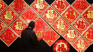 People purchase Fu character ornaments, which is the Mandarin character for "prosperity", for the upcoming Chinese New Year at a wholesale market.